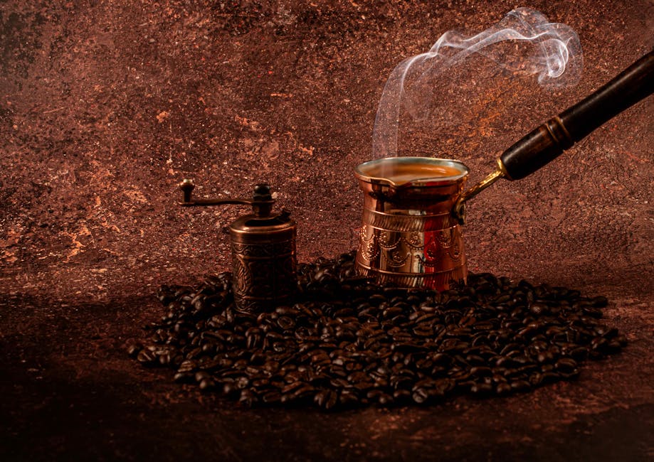 Aromatic Turkish coffee brewing in a cezve with steam rising, surrounded by roasted coffee beans and a vintage grinder.
