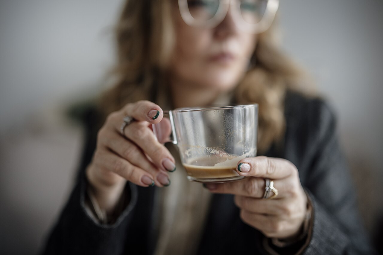 Puerto Rican woman coffee roaster operating a commercial roasting machine in a specialty roastery