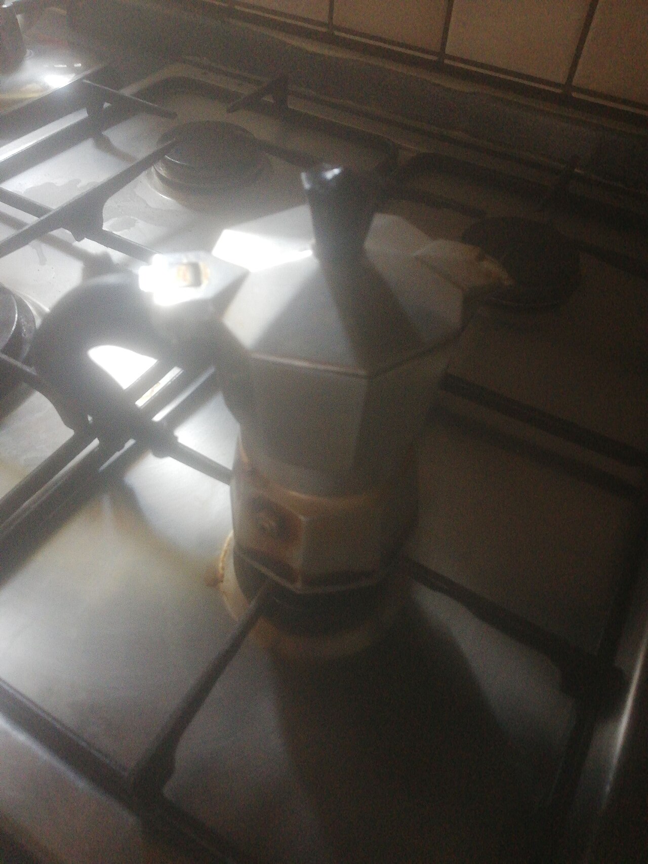 Puerto Rican coffee being brewed in traditional stovetop cafetera, steam rising, rustic setting, preparation of bitter coffee