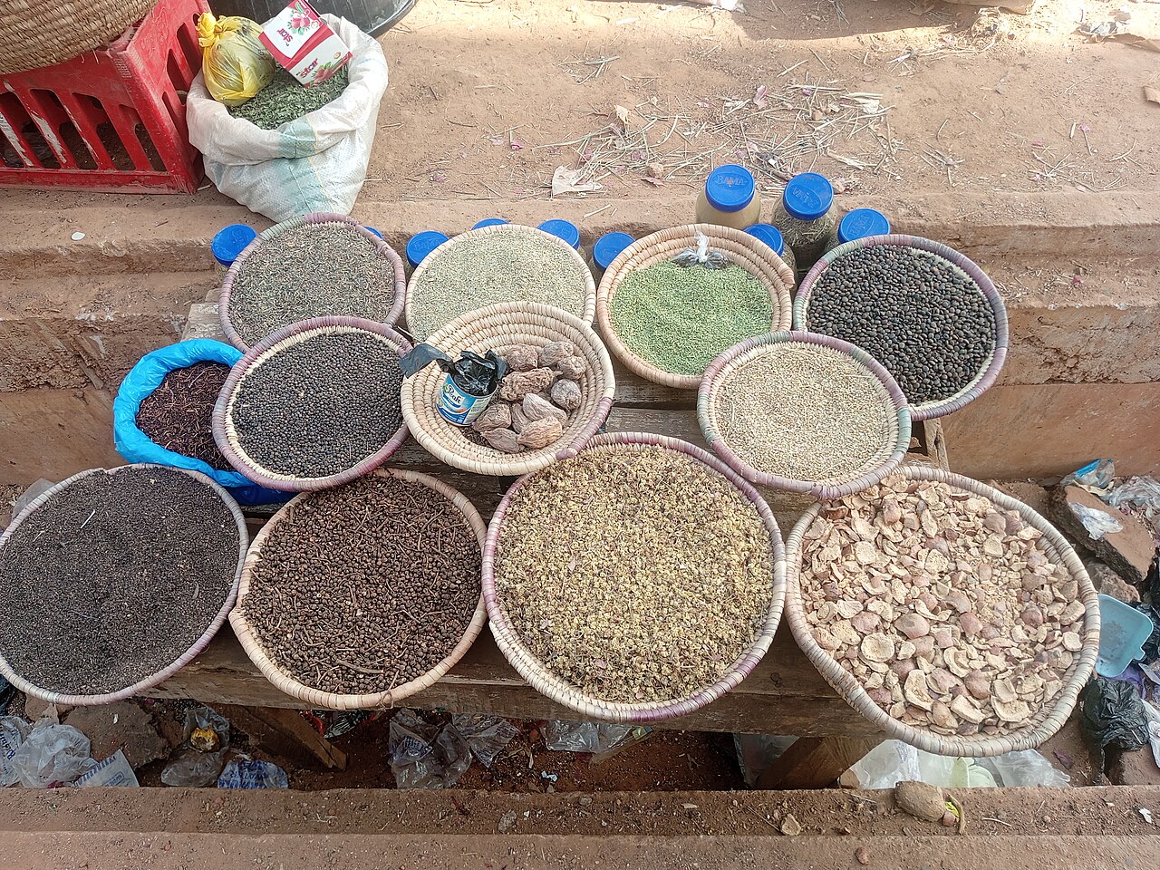 Puerto Rican coffee beans in a wooden bowl, roasted to medium-dark, with a vintage coffee grinder in background
