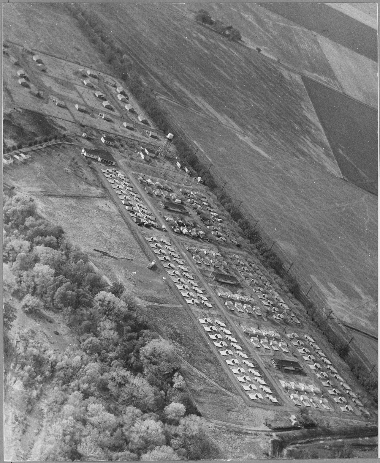Financial spreadsheet and receipts on a Puerto Rican coffee farmer's kitchen table showing farm economics (Wikimedia: Sacramento, California. Air view of Winters Farm Works Community (F.S.A.) with f, Public domain)