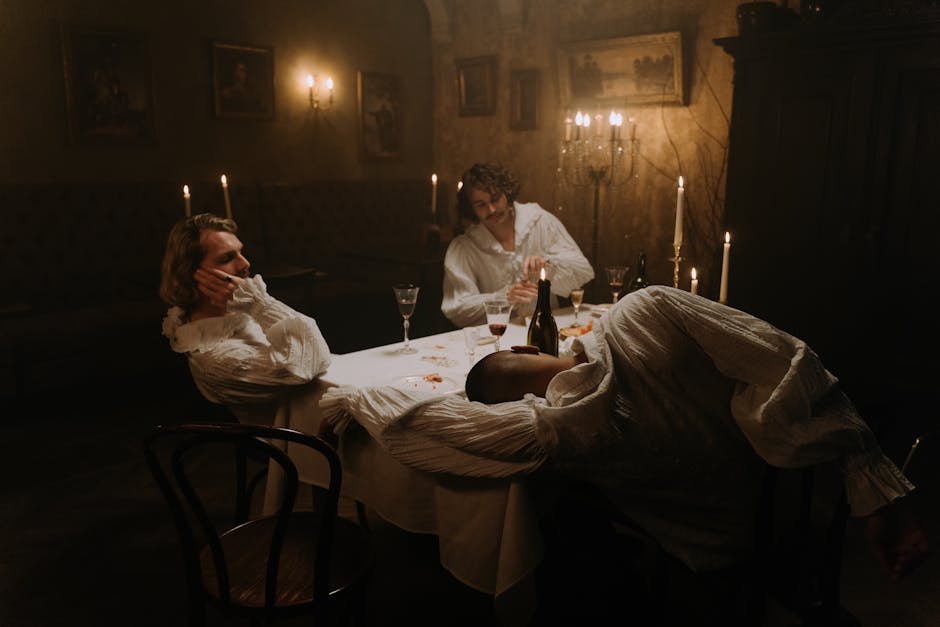Elegant scene of men in period costumes having a candlelit dinner with wine.