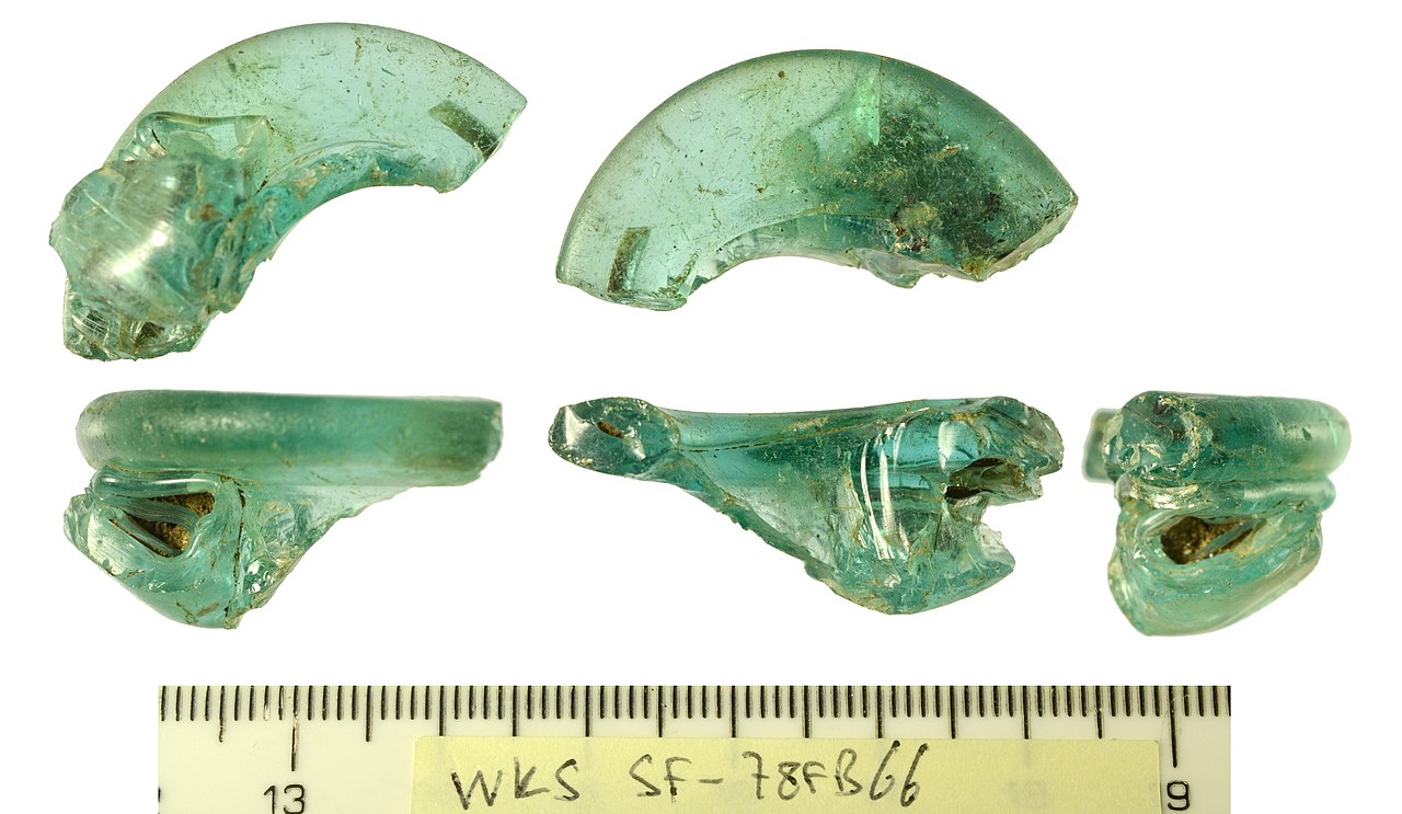 Multiple small glass bottles of homemade coquito lined up with different family recipes, gift-giving tradition, festive ribbons