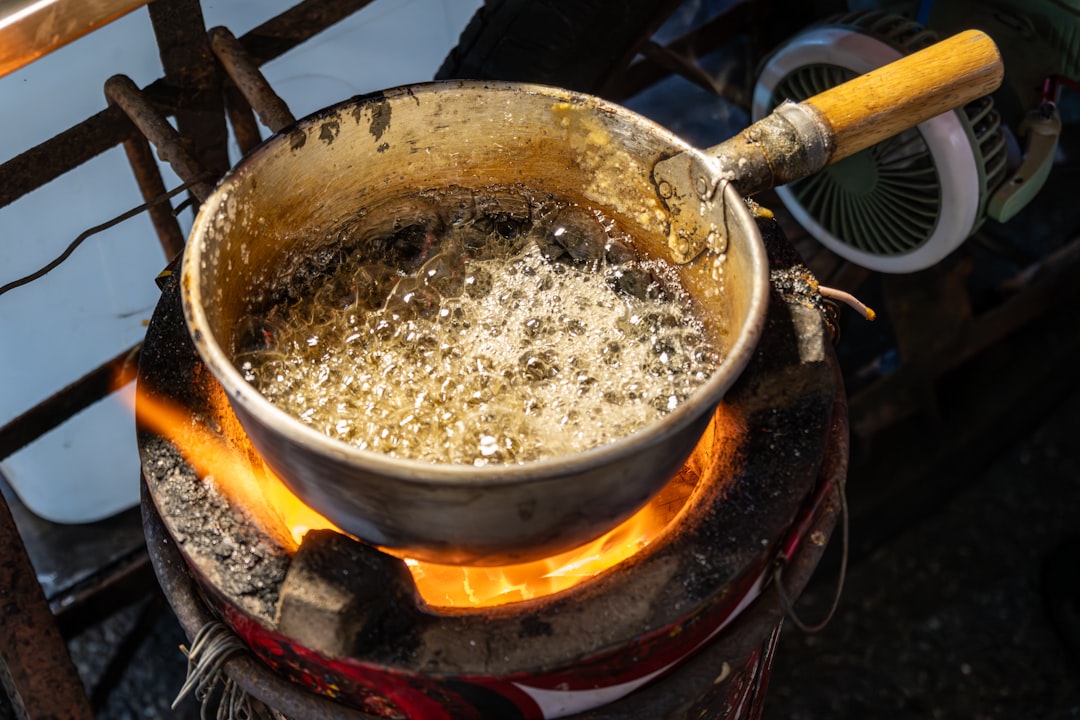 Sugar caramelizing in a saucepan turning golden amber, being swirled in a pan, careful technique required