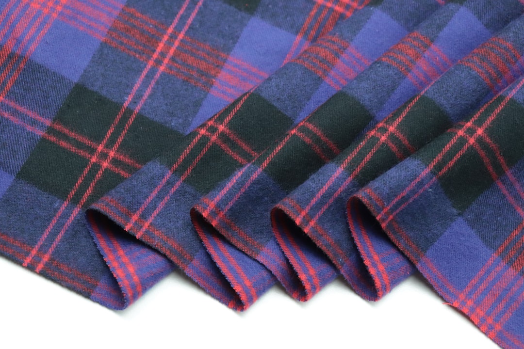 close-up detail of a traditional flannel colador filter, hand-stitched seams, wooden handle, hanging from a wall hook in a Puerto Rican kitchen