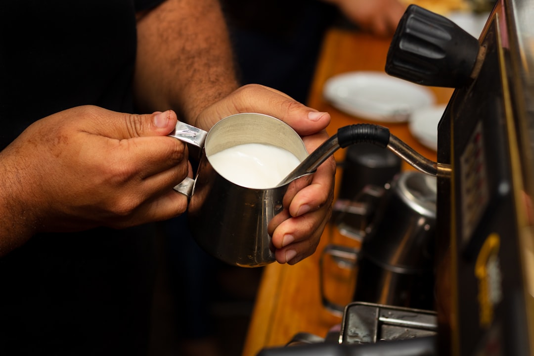 Traditional Puerto Rican café con leche preparation on stovetop showing ingredient combination