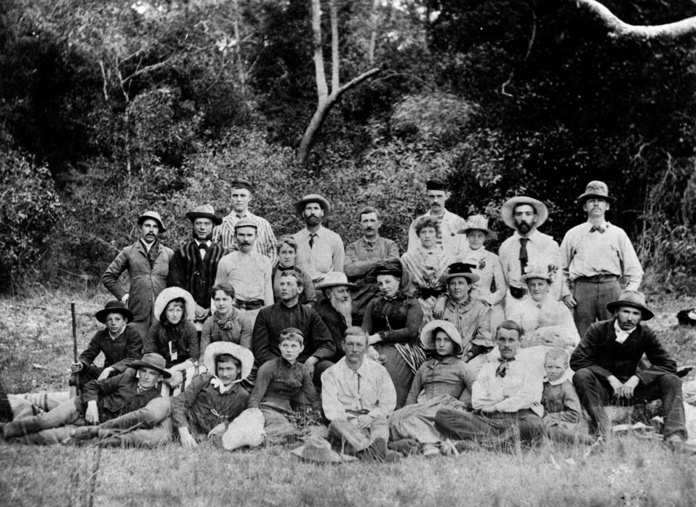Puerto Rican family Christmas gathering with coquito being poured, plates of traditional food, festive atmosphere
