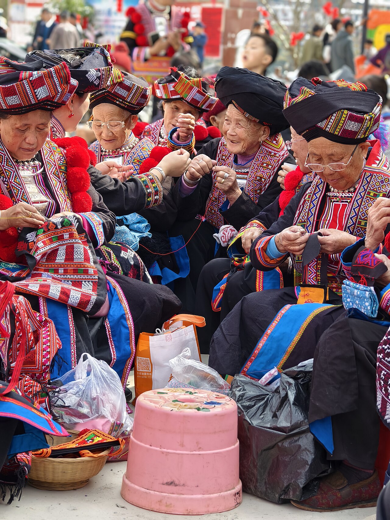 International visitor picking coffee cherries alongside Puerto Rican farm workers during harvest (Wikimedia: Yao people's Harvest Festival in Nala Village - 10.jpg, CC BY-SA 4.0)