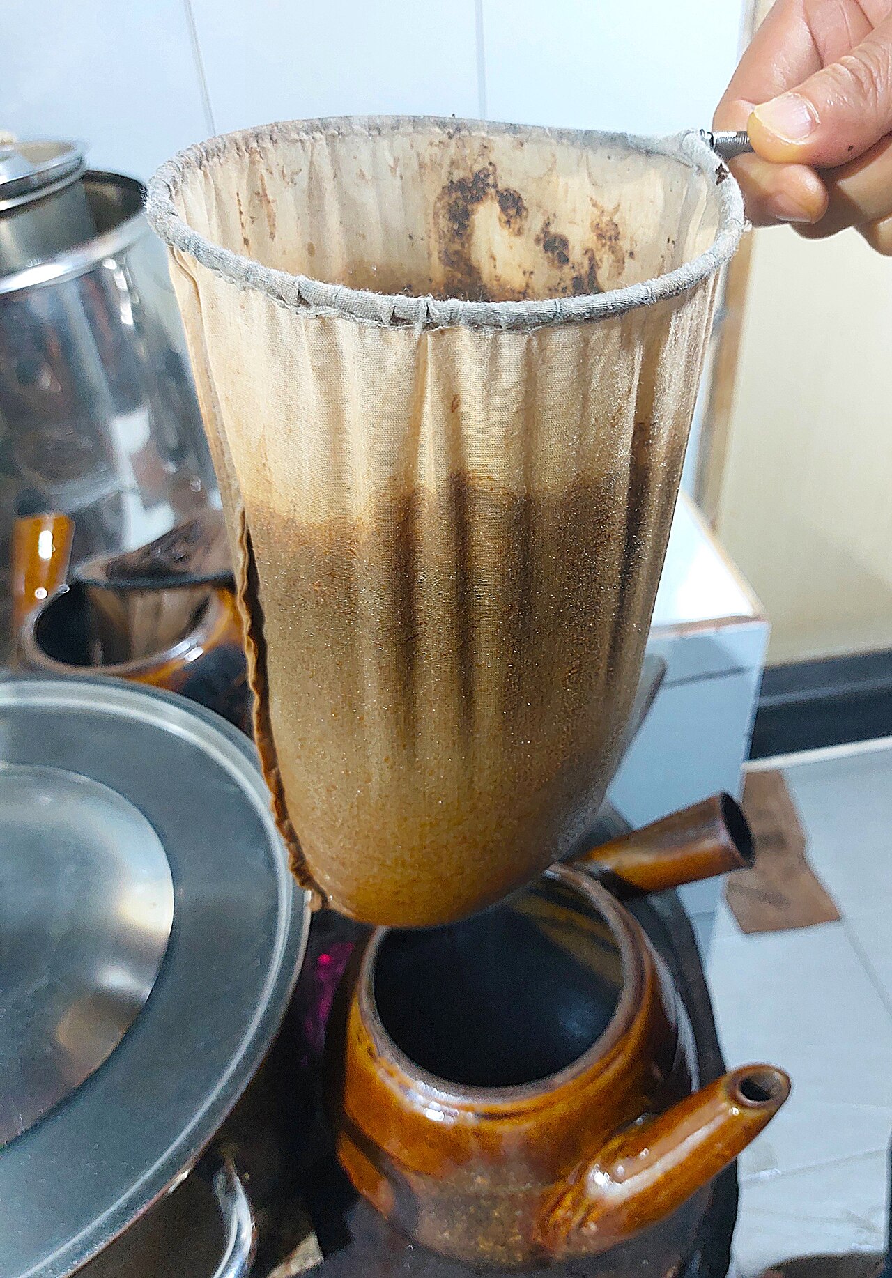 Traditional Puerto Rican colador cloth coffee filter sock in use for brewing café criollo