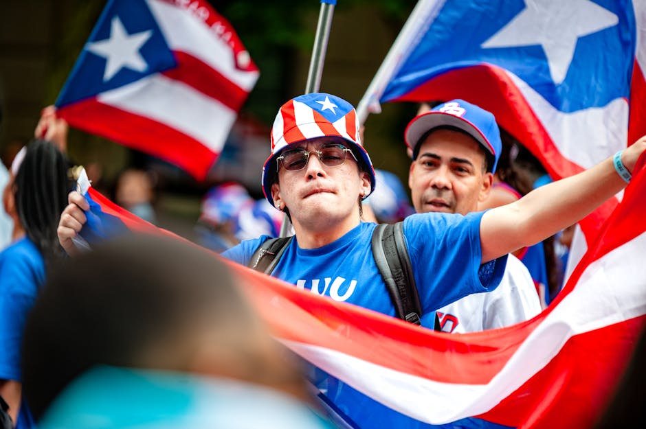 Joyful participants wave Puerto Rican flags during a vibrant parade in New York City.