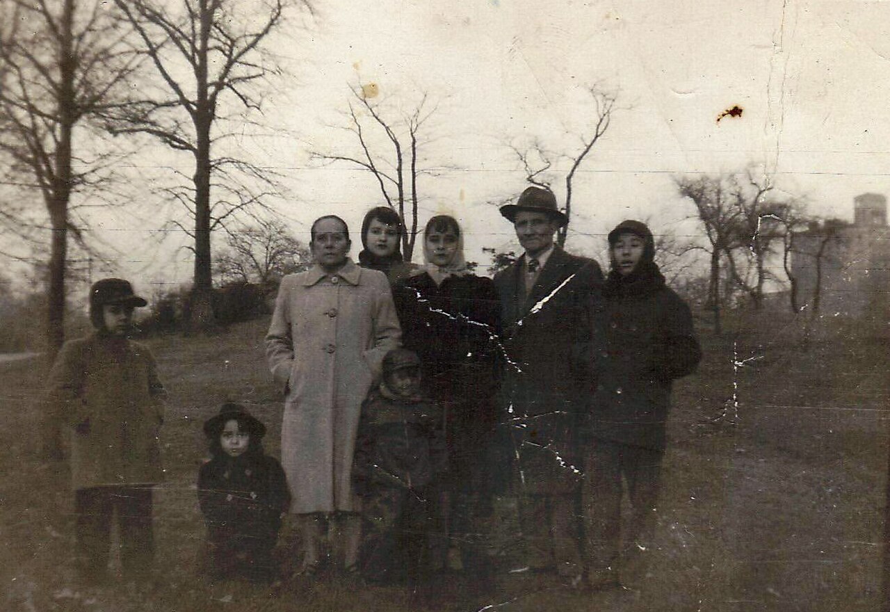 Puerto Rican family gathered around kitchen table with café de la olla being served, multigenerational scene, Christmas decorations visible