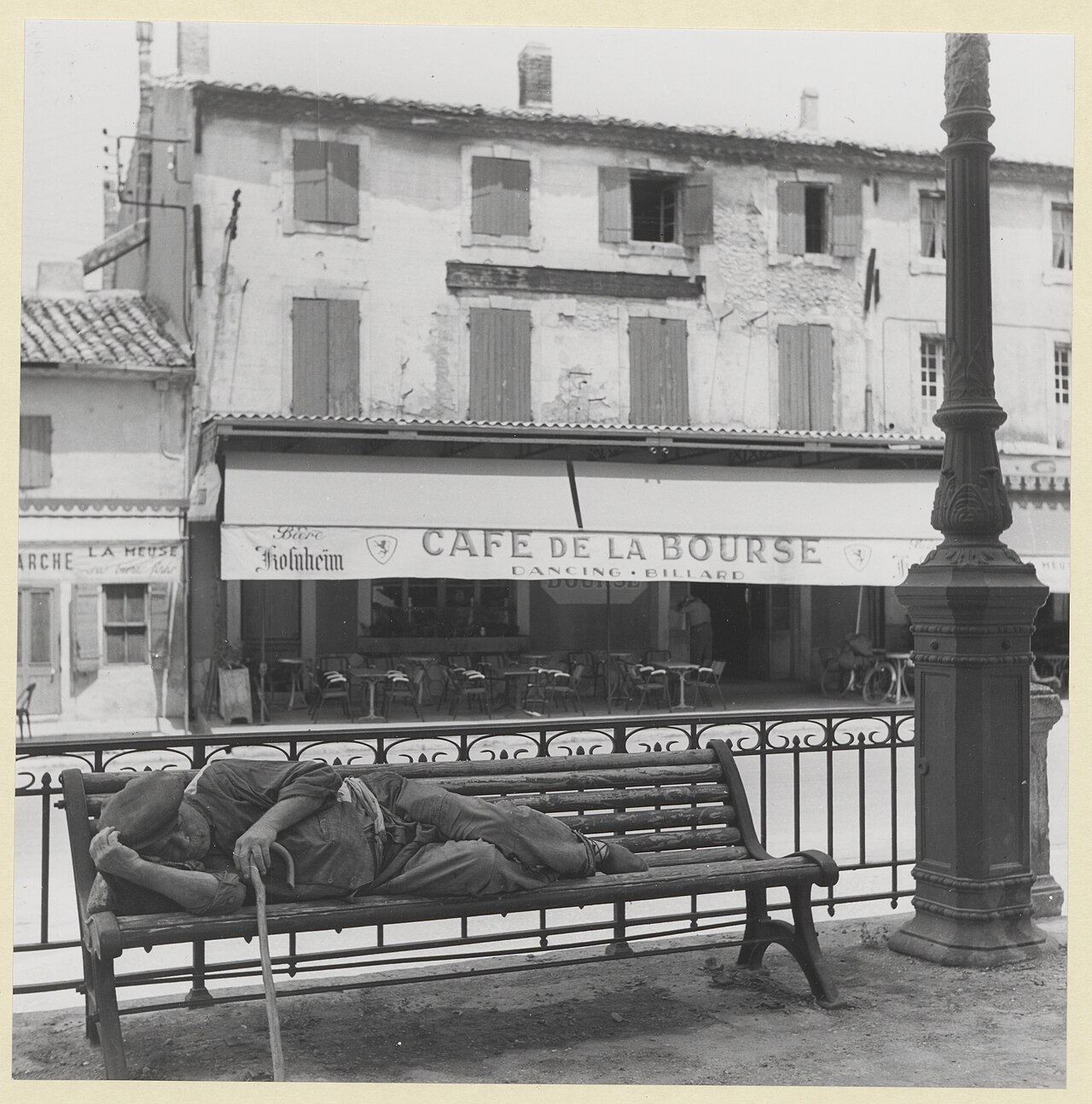 traditional wooden-handled colador de café sock filter held over a metal coffee pot, hot water being poured slowly through the cloth filter, steam rising in warm kitchen light