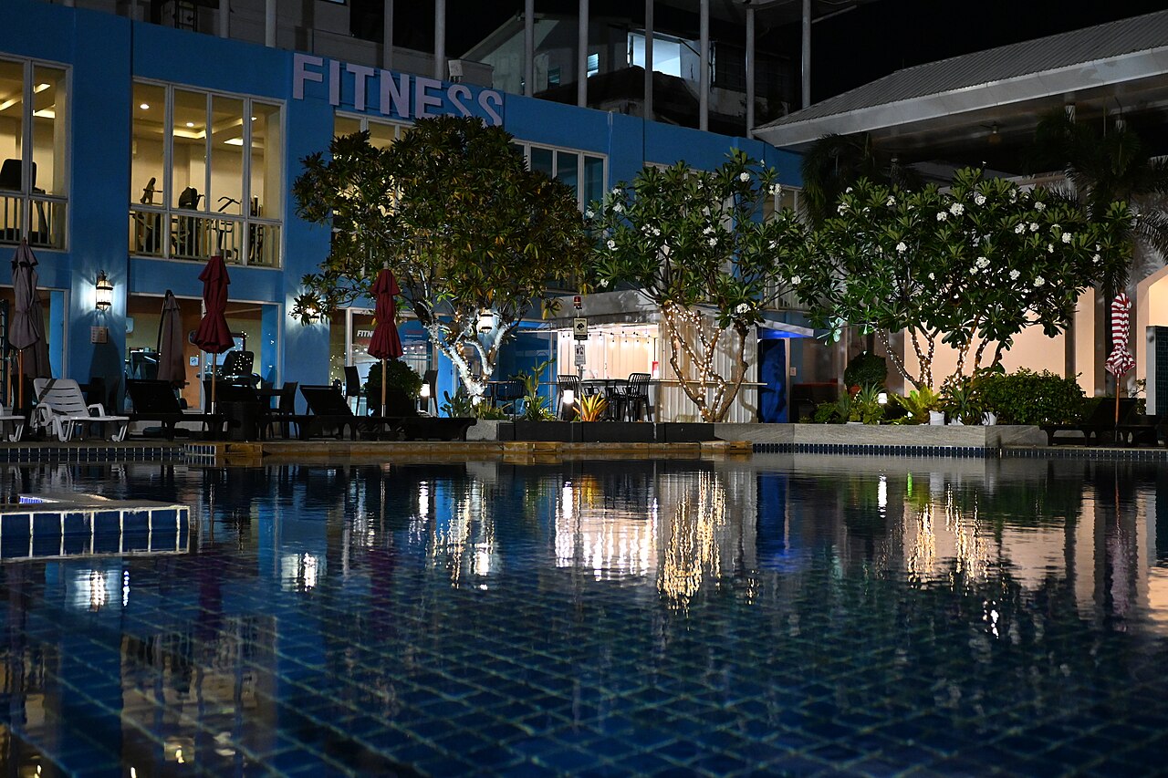 clear glass of water beside coffee cup on wooden surface