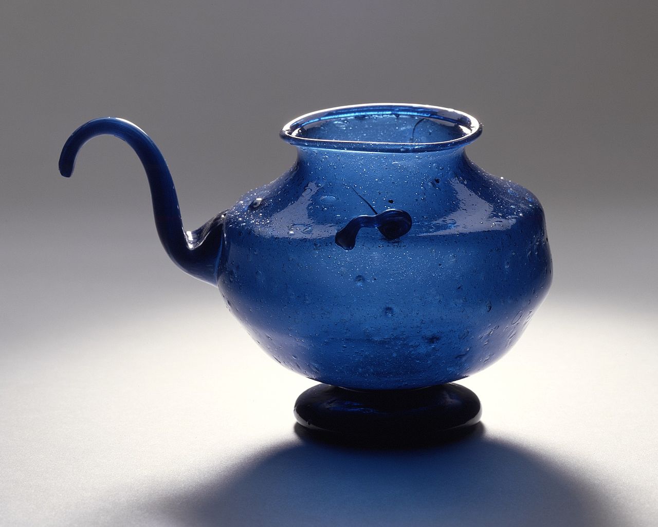 Close-up showing the curved spout of a gooseneck kettle in cross-section, with arrows indicating the flow path and bend angles