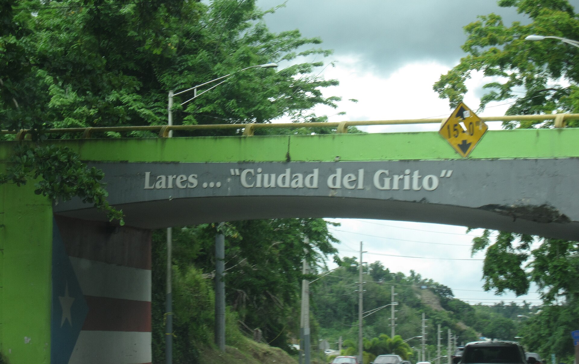 Bridge in Lares, Puerto Rico marked Lares — Ciudad del Grito, with the Puerto Rican flag