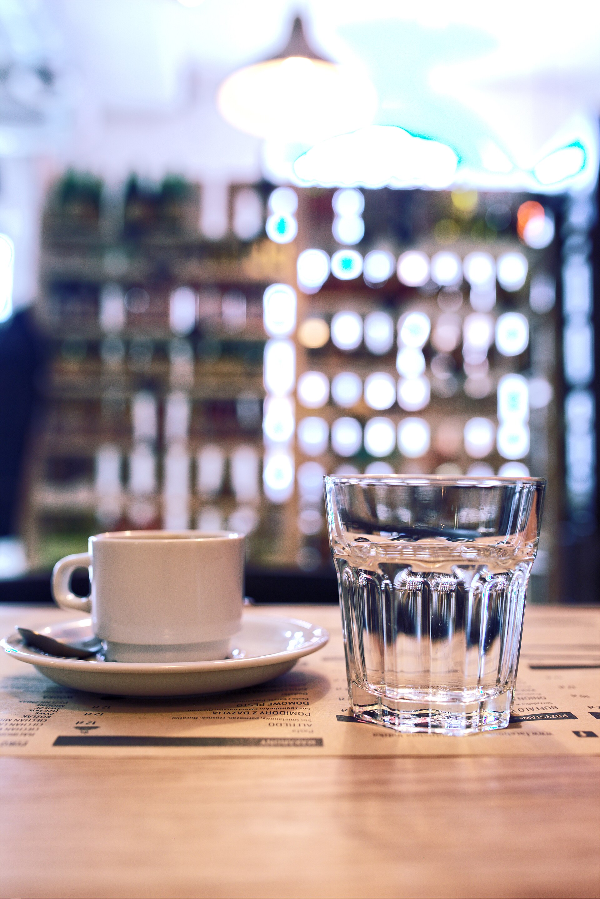 A cup of coffee beside a glass of water — brewed coffee is about 98.75 percent water
