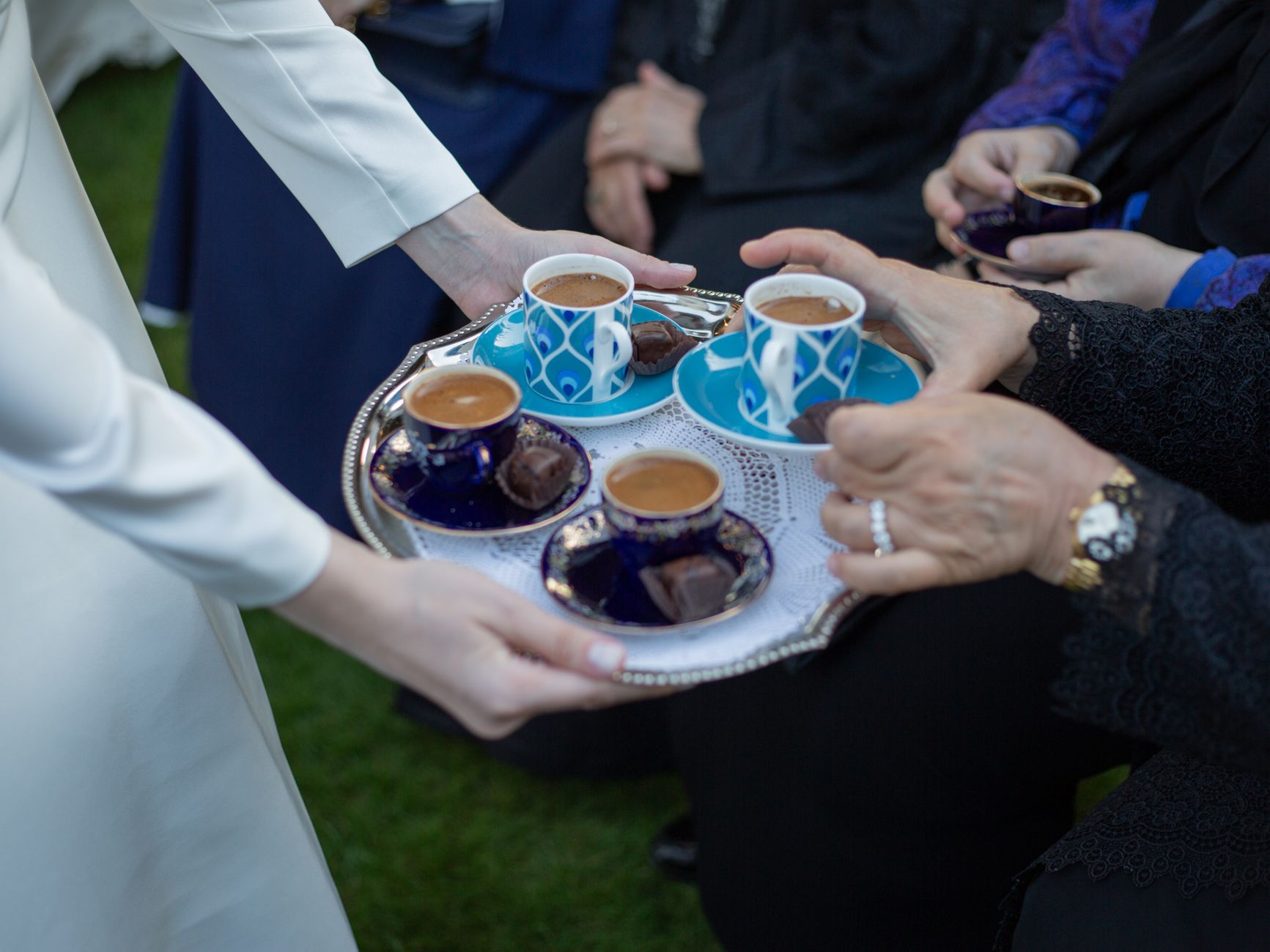 Small cups of coffee served from a tray to guests at a family gathering