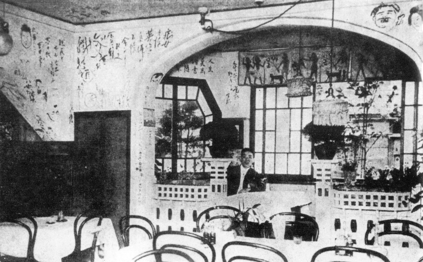 The interior of Café Printemps in Ginza, Tokyo, photographed between 1911 and 1923: bentwood chairs and white-clothed tables beneath walls covered in handwritten inscriptions and drawings.