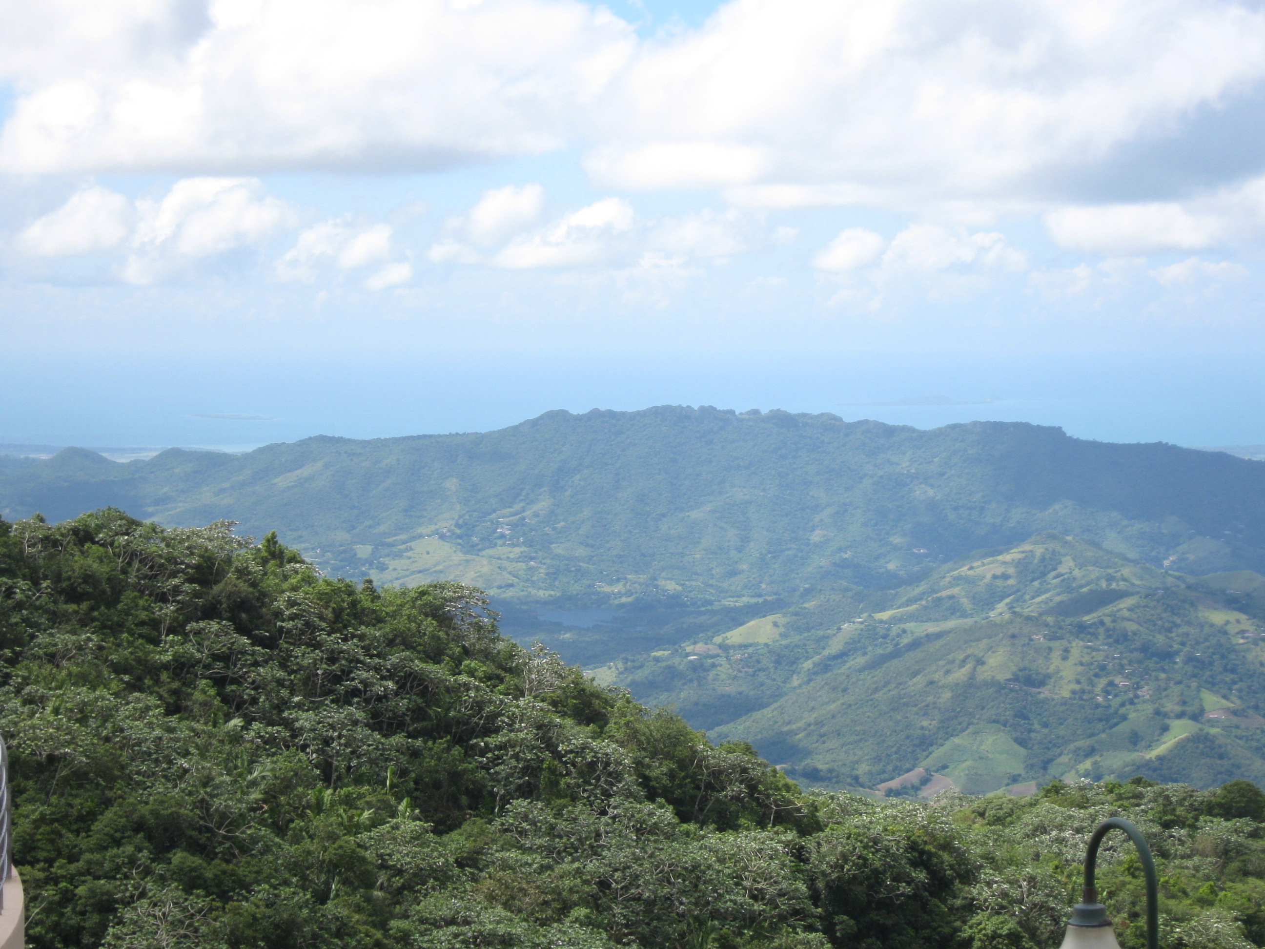 The Cordillera Central seen from the lookout between Villalba and Orocovis, its forested ridges falling toward the sea on the horizon.