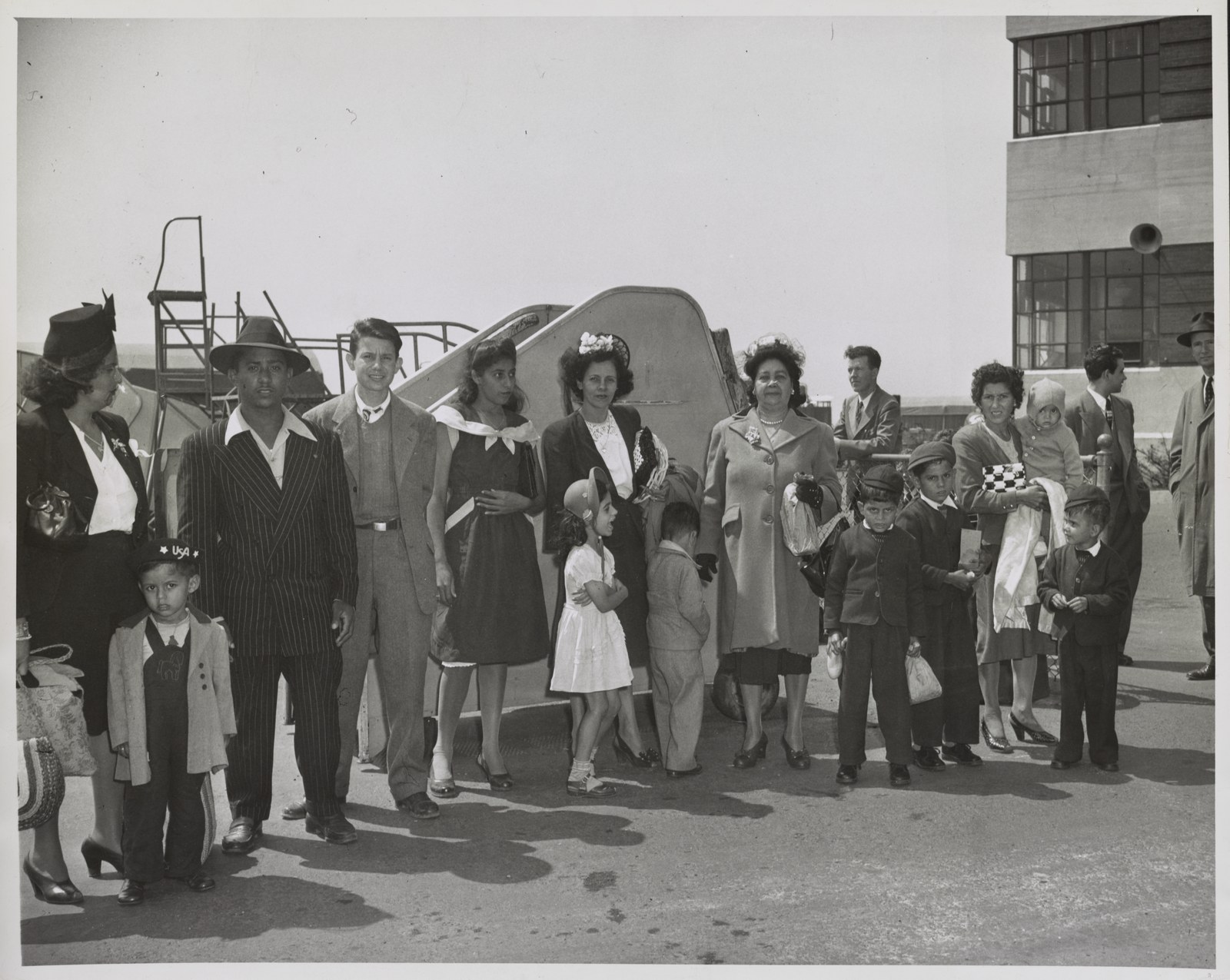 A group of Puerto Ricans who had just arrived by plane from Puerto Rico, at Newark Airport, New Jersey, in 1947, waiting to be taken on to New York.
