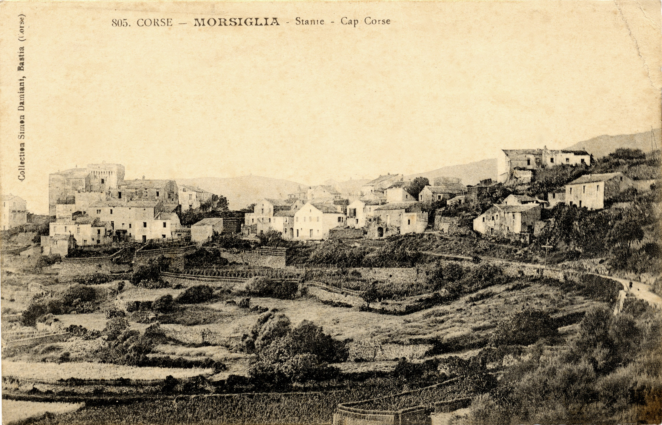 A sepia postcard of a Corsican hill village of stone houses above terraced fields.